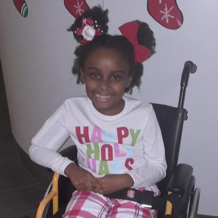 Melodia in her wheelchair comfortable, patient and adjusting to new norms.